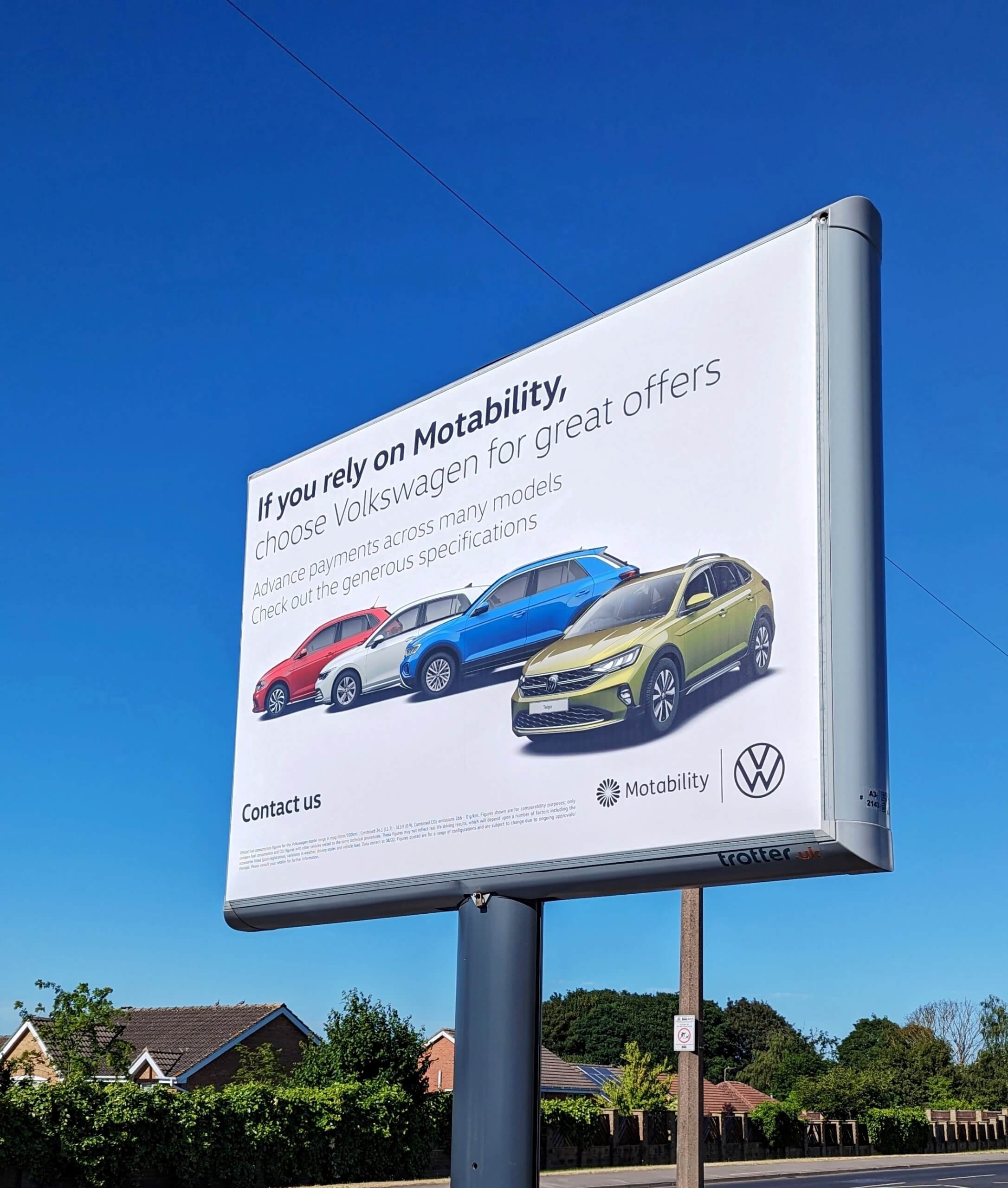 Large billboard sign for Volkswagon with cars on a white background. Poster reads 'if you rely on motability'