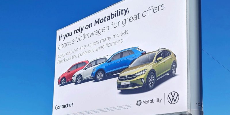 Large billboard sign for Volkswagon with cars on a white background. Poster reads 'if you rely on motability'